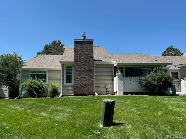 13908 E Linvale Pl, Aurora, CO 80014 - rear view of house featuring a lawn, a shingled roof, and a chimney