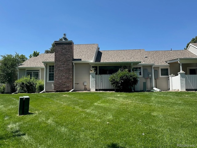 13908 E Linvale Pl, Aurora, CO 80014 - back of property with a lawn, a chimney, and a shingled roof