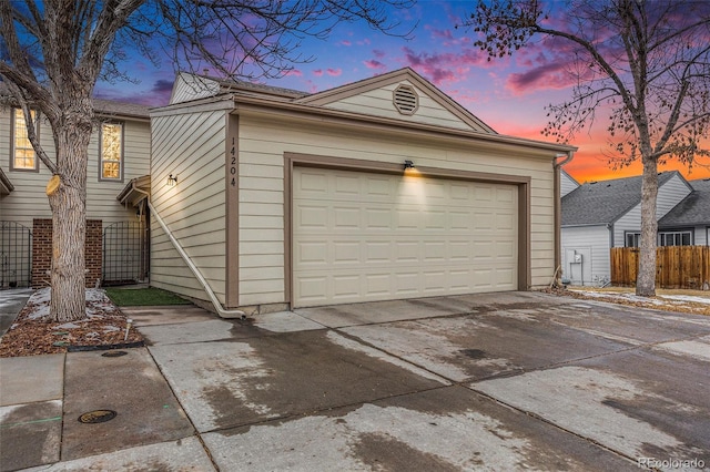 view of garage at dusk