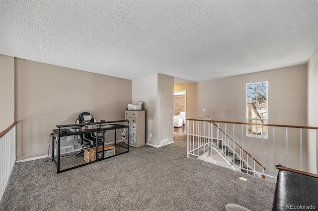 interior space featuring carpet floors and a textured ceiling