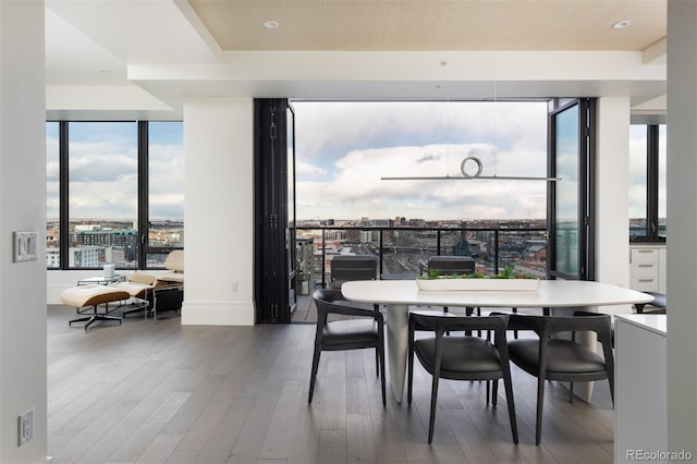 dining space with wood-type flooring