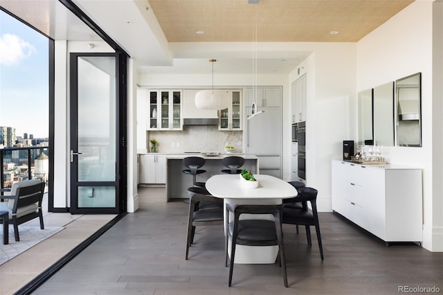 dining room with wood ceiling and dark hardwood / wood-style floors