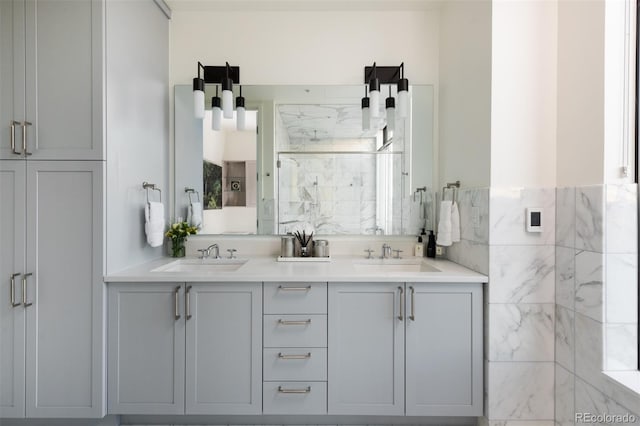 bathroom with vanity, tile walls, and walk in shower