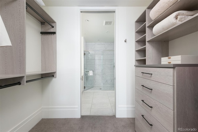 spacious closet with light tile patterned floors