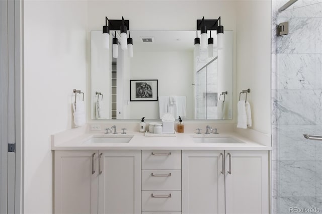 bathroom featuring vanity and an enclosed shower