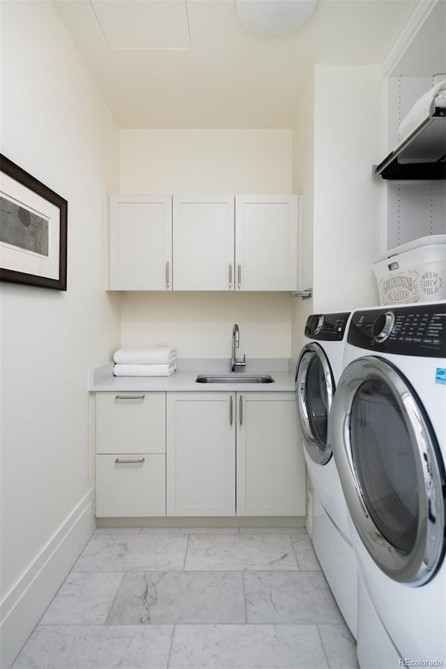 laundry area with cabinets, sink, and washer and dryer