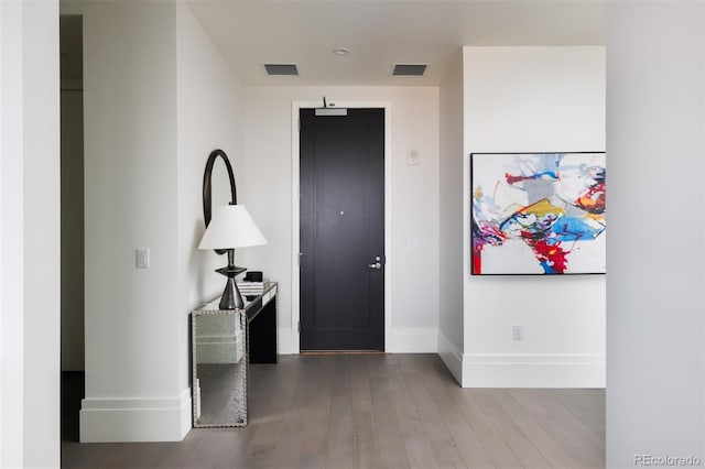 corridor with hardwood / wood-style flooring