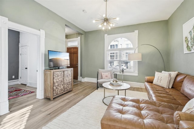 living room with a chandelier and light hardwood / wood-style flooring