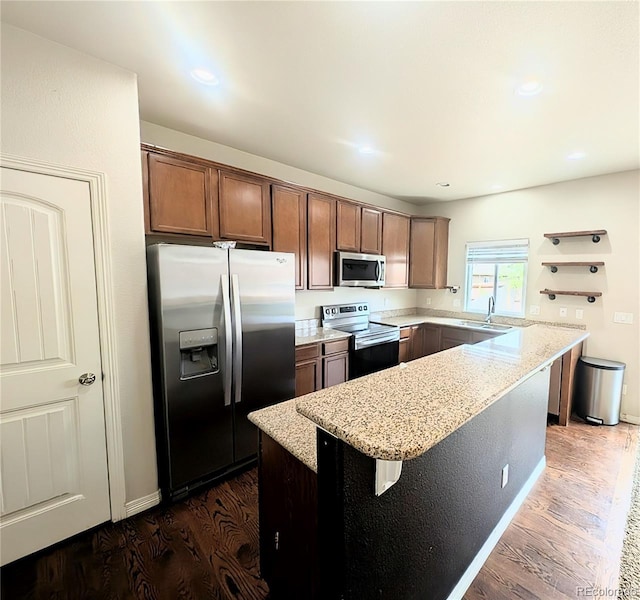 7958 Lightwood Way, Colorado Springs, CO 80908 - kitchen featuring appliances with stainless steel finishes, dark wood-type flooring, light stone countertops, open shelves, and recessed lighting