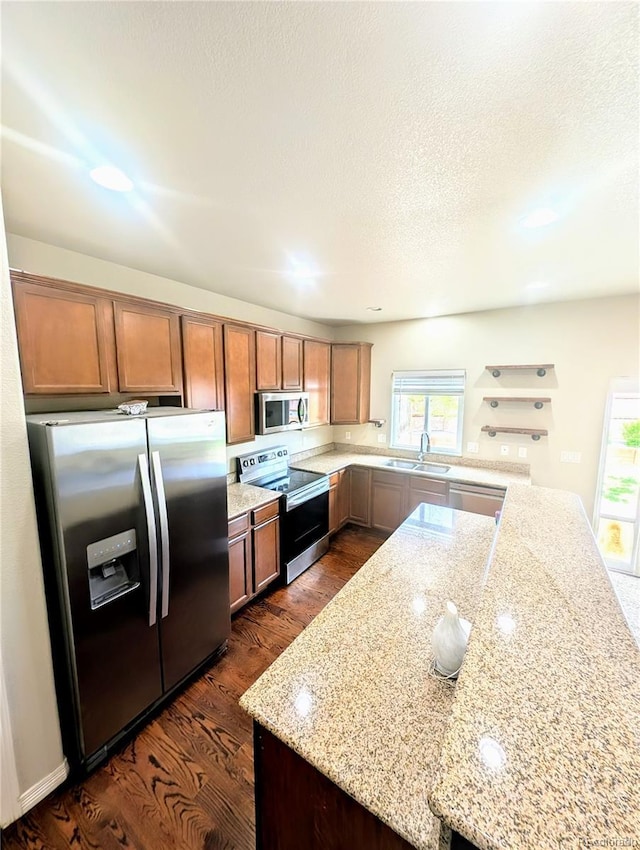 7958 Lightwood Way, Colorado Springs, CO 80908 - kitchen with stainless steel appliances, a sink, dark wood-style flooring, light stone counters, and open shelves