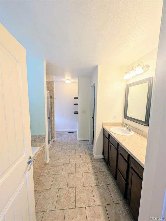 7958 Lightwood Way, Colorado Springs, CO 80908 - full bath featuring a stall shower, vanity, a bath, and a textured ceiling
