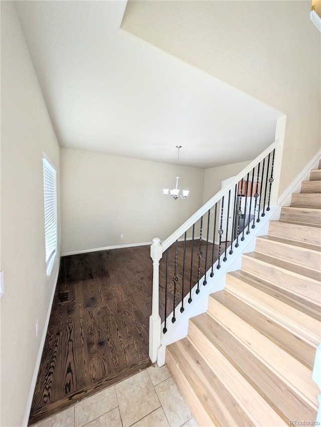 7958 Lightwood Way, Colorado Springs, CO 80908 - staircase featuring a chandelier, baseboards, and tile patterned floors