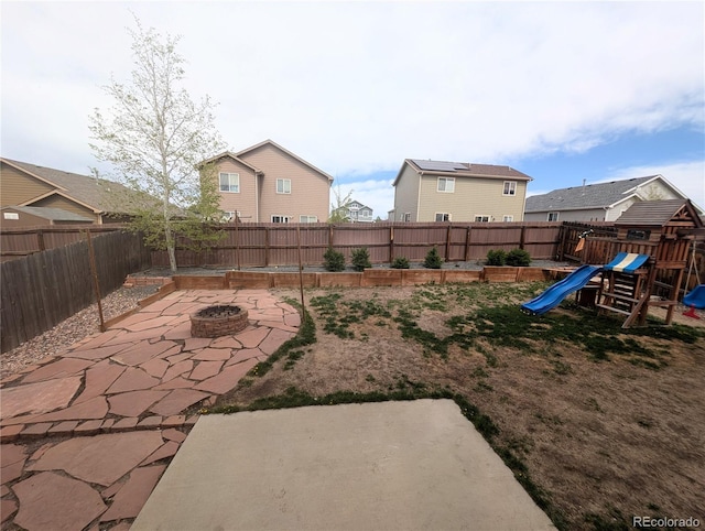 7958 Lightwood Way, Colorado Springs, CO 80908 - fenced backyard with a patio, a fire pit, and a playground