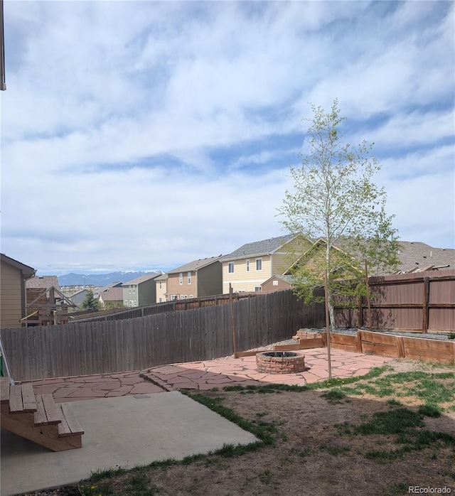 7958 Lightwood Way, Colorado Springs, CO 80908 - fenced backyard featuring a patio area, an outdoor fire pit, and a residential view
