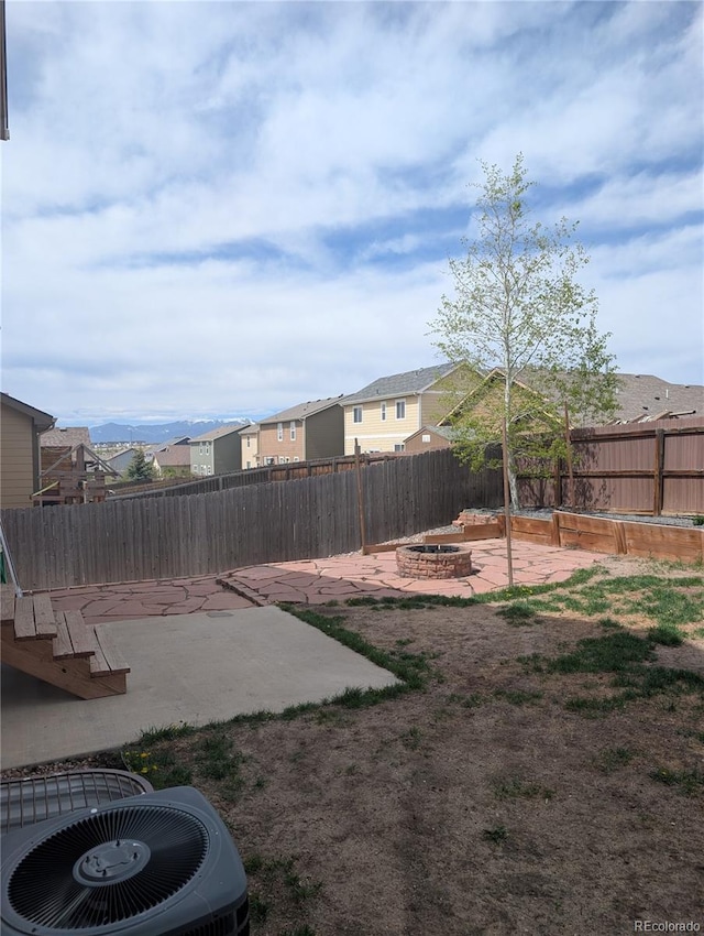 7958 Lightwood Way, Colorado Springs, CO 80908 - fenced backyard featuring an outdoor fire pit, a patio area, central AC, and a residential view
