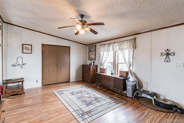7080 S Calhan Rd, Calhan, CO 80808 - office area with crown molding, a textured ceiling, ceiling fan, and wood finished floors