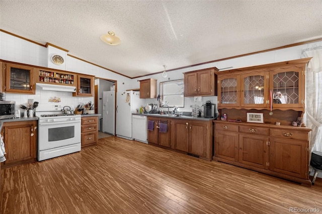 7080 S Calhan Rd, Calhan, CO 80808 - kitchen with crown molding, lofted ceiling, white appliances, and a textured ceiling