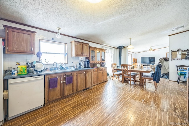 7080 S Calhan Rd, Calhan, CO 80808 - kitchen with hardwood / wood-style floors, ornamental molding, a textured ceiling, dishwasher, and a ceiling fan