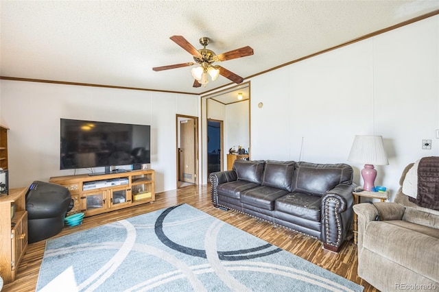 7080 S Calhan Rd, Calhan, CO 80808 - living room featuring crown molding, a textured ceiling, wood finished floors, and a ceiling fan
