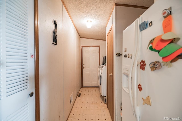 7080 S Calhan Rd, Calhan, CO 80808 - hall with washing machine and dryer, light floors, and a textured ceiling