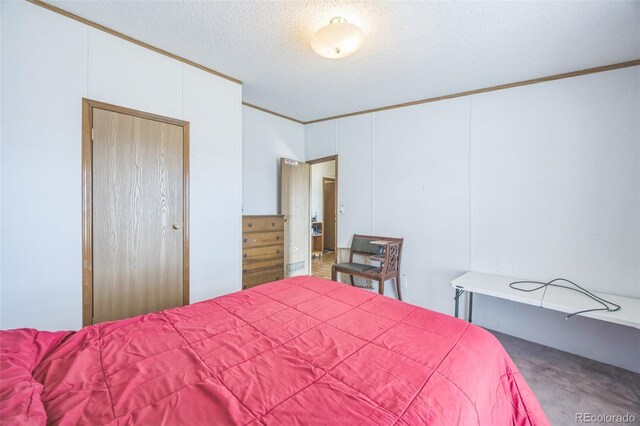 7080 S Calhan Rd, Calhan, CO 80808 - bedroom featuring a textured ceiling, ornamental molding, and carpet