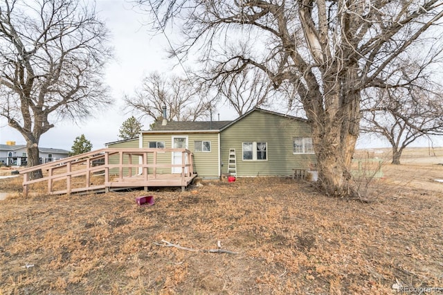 7080 S Calhan Rd, Calhan, CO 80808 - rear view of house featuring a wooden deck and a chimney