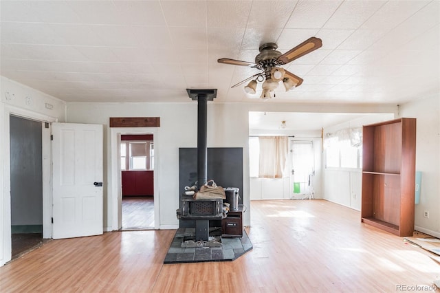 7080 S Calhan Rd, Calhan, CO 80808 - living area featuring a wood stove, ceiling fan, and wood finished floors