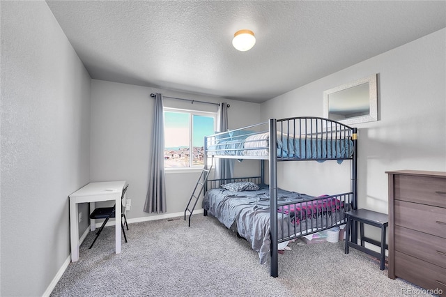 bedroom with carpet flooring, a textured ceiling, and baseboards