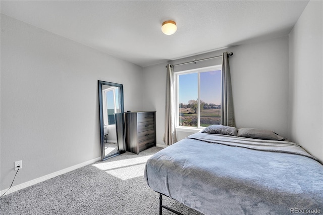 bedroom featuring light carpet and baseboards