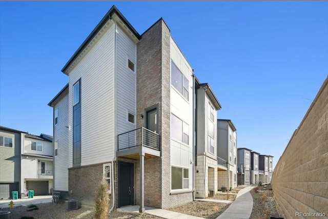 view of building exterior featuring a garage and central AC unit