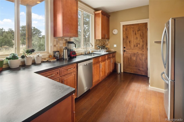 147 Moonlight Way, Crestone, CO 81131 - kitchen with stainless steel appliances, a sink, dark wood-type flooring, dark countertops, and brown cabinets