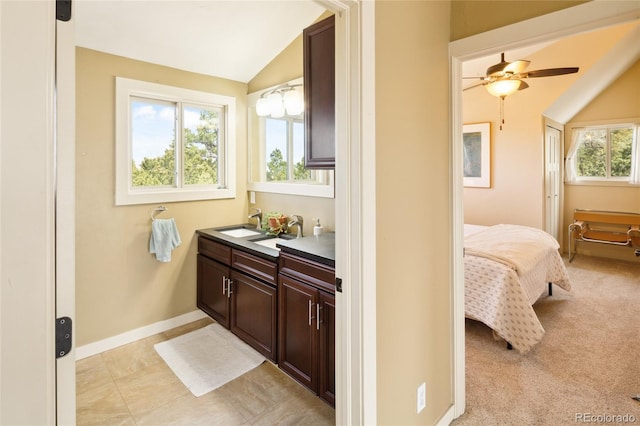 147 Moonlight Way, Crestone, CO 81131 - bathroom featuring lofted ceiling, ceiling fan, double vanity, and baseboards