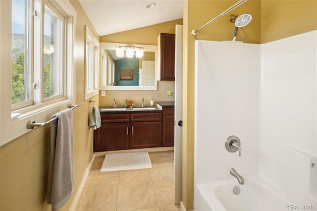 147 Moonlight Way, Crestone, CO 81131 - full bath featuring vaulted ceiling, bathtub / shower combination, double vanity, tile patterned floors, and baseboards