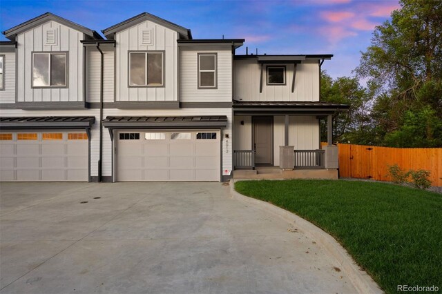 4008 Upham St, Wheat Ridge, CO 80033 - townhome / multi-family property featuring board and batten siding, an attached garage, driveway, and a porch