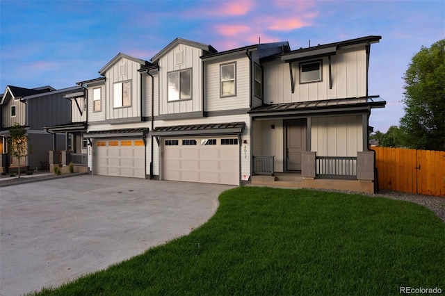 4008 Upham St, Wheat Ridge, CO 80033 - view of front of property with an attached garage, concrete driveway, board and batten siding, a standing seam roof, and a metal roof