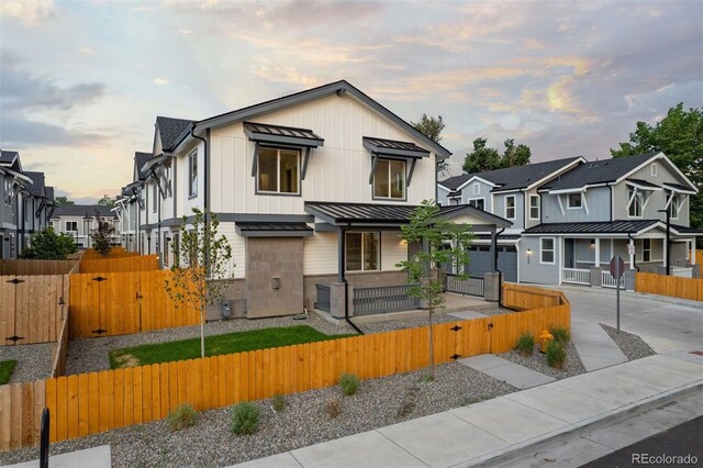 4008 Upham St, Wheat Ridge, CO 80033 - view of front facade featuring a standing seam roof, a fenced front yard, a gate, a metal roof, and covered porch