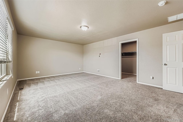 5841 Echo Park Cir, Castle Rock, CO 80104 - unfurnished bedroom with carpet floors, a textured ceiling, and a spacious closet