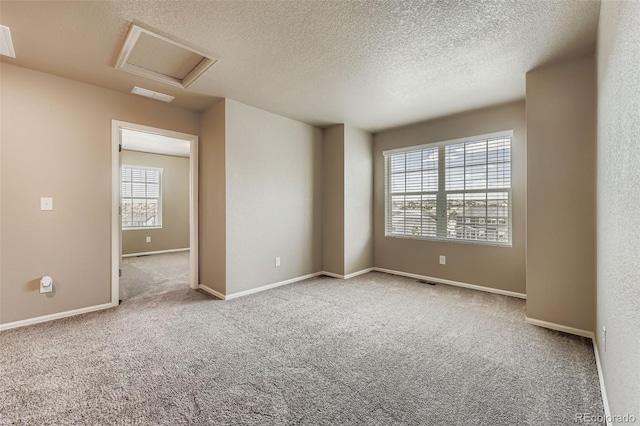 5841 Echo Park Cir, Castle Rock, CO 80104 - carpeted spare room featuring attic access and a textured ceiling