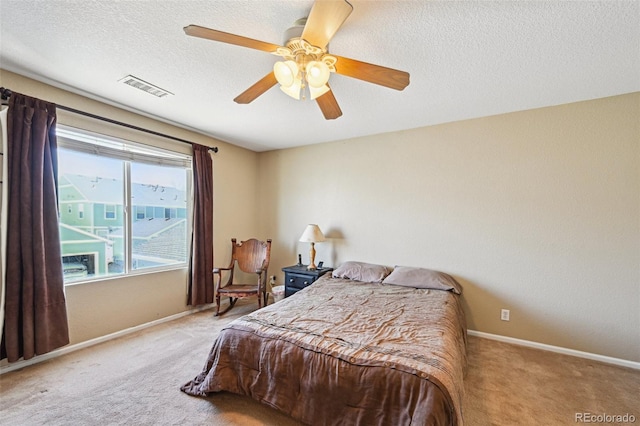 bedroom with carpet, visible vents, baseboards, and ceiling fan