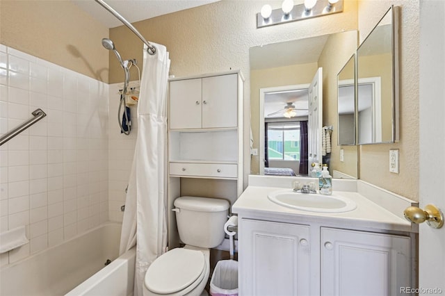 full bath with toilet, ceiling fan, a textured wall, shower / bathtub combination with curtain, and vanity