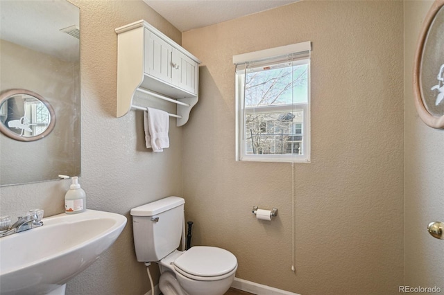 half bathroom with a sink and toilet