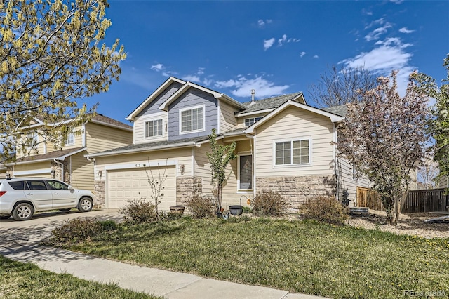 412 Iron St, Brighton, CO 80603 - view of front of home with stone siding, concrete driveway, and an attached garage