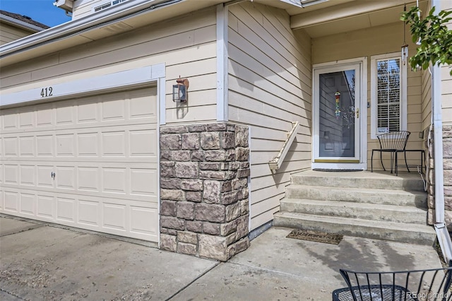 412 Iron St, Brighton, CO 80603 - view of exterior entry with a garage