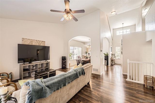 412 Iron St, Brighton, CO 80603 - living area with arched walkways, dark wood-style floors, ceiling fan, and high vaulted ceiling