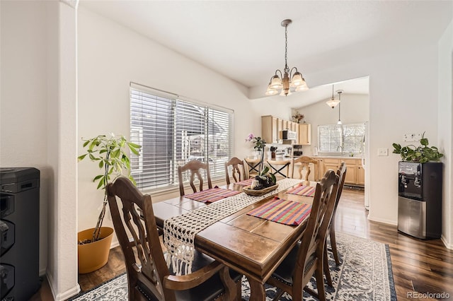 412 Iron St, Brighton, CO 80603 - dining space featuring a chandelier, healthy amount of natural light, and dark wood finished floors