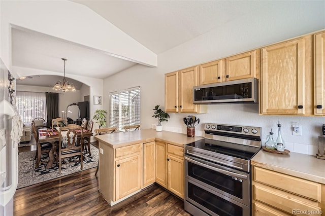 412 Iron St, Brighton, CO 80603 - kitchen with light brown cabinetry, appliances with stainless steel finishes, vaulted ceiling, a chandelier, and a peninsula