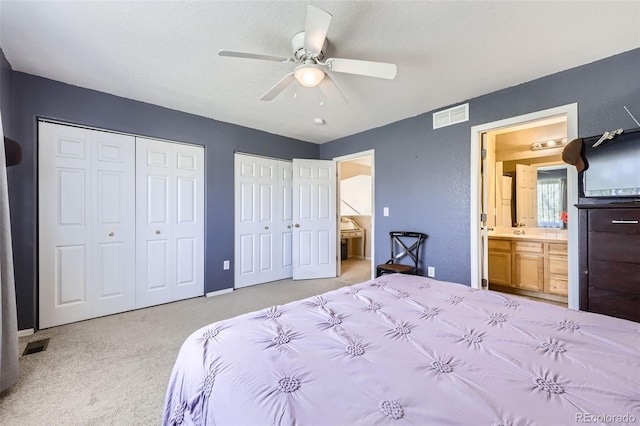 412 Iron St, Brighton, CO 80603 - bedroom with two closets, light colored carpet, ensuite bath, and a ceiling fan