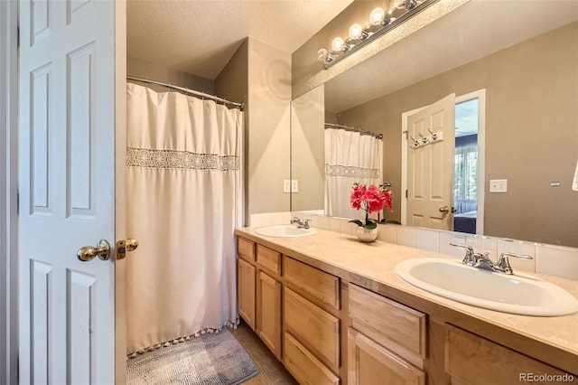 412 Iron St, Brighton, CO 80603 - bathroom featuring double vanity, ensuite bath, tile patterned flooring, and a textured ceiling