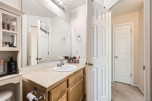 412 Iron St, Brighton, CO 80603 - bathroom featuring vanity and toilet