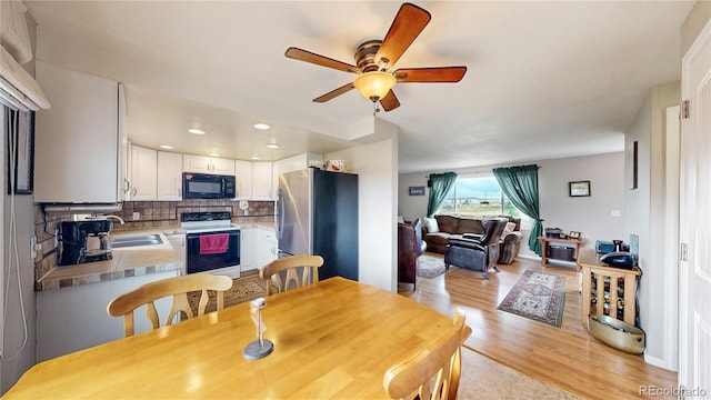 4160 Converse Rd, Bennett, CO 80102 - dining space featuring light wood finished floors, ceiling fan, and recessed lighting